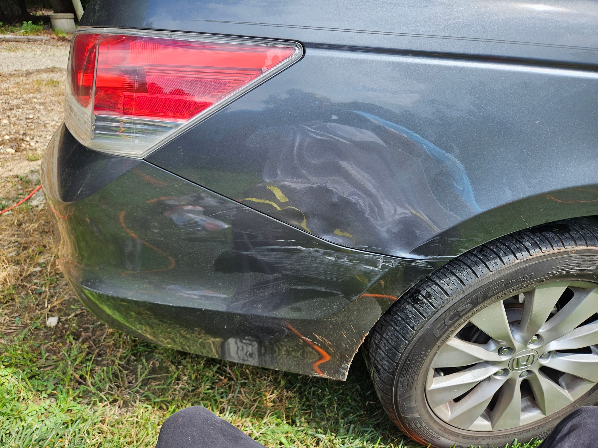Before photo of gray Honda Accord rear quarter panel with a dent and scraped bumper corner showing paint transfer