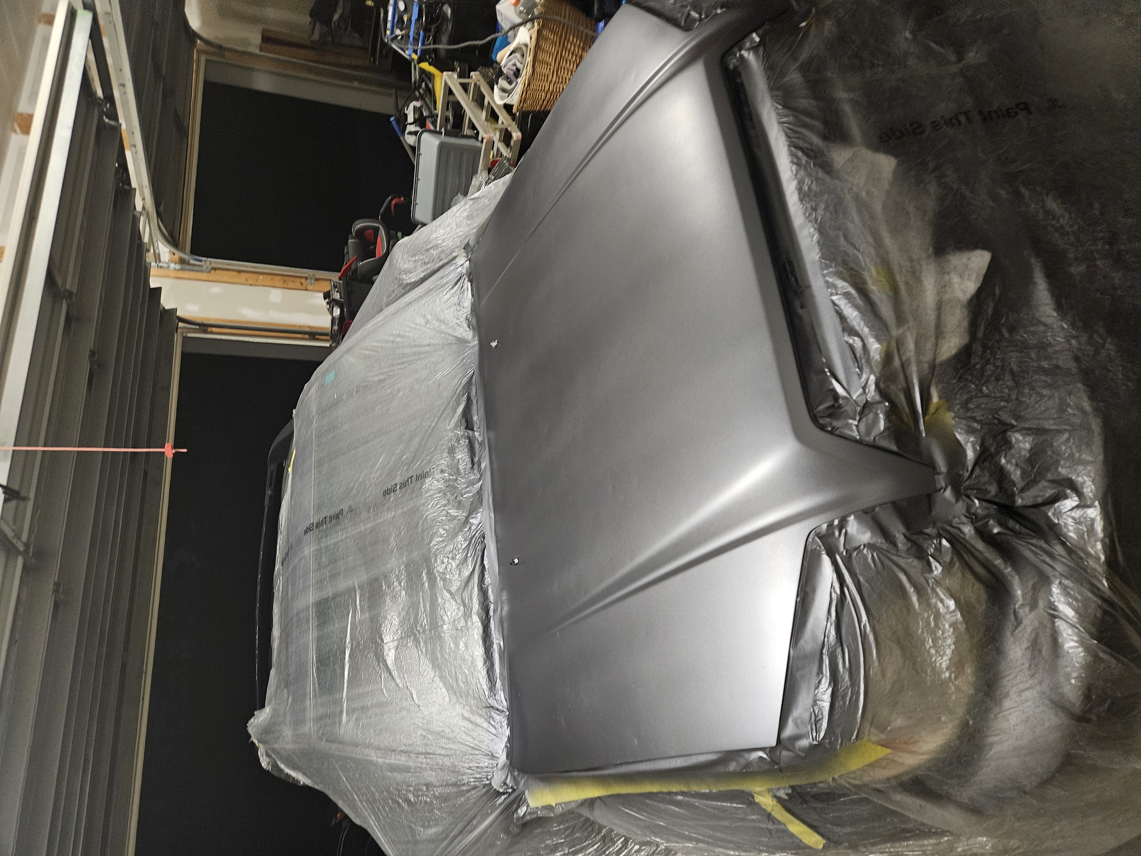 After photo of blue Toyota Tacoma hood prepped to fresh primer and ready for refinish
