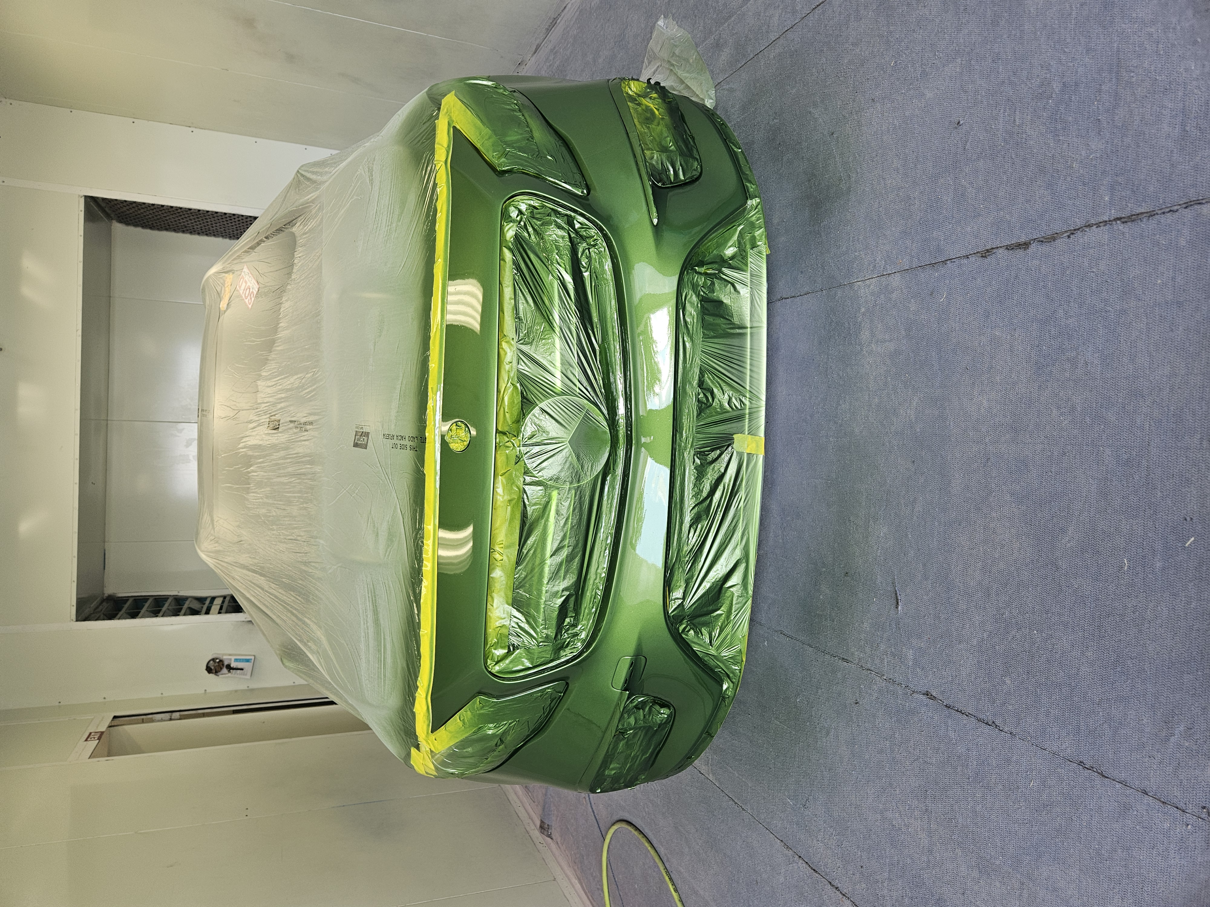 After photo of green Mercedes-Benz GLE front bumper refinished and color-matched in metallic green