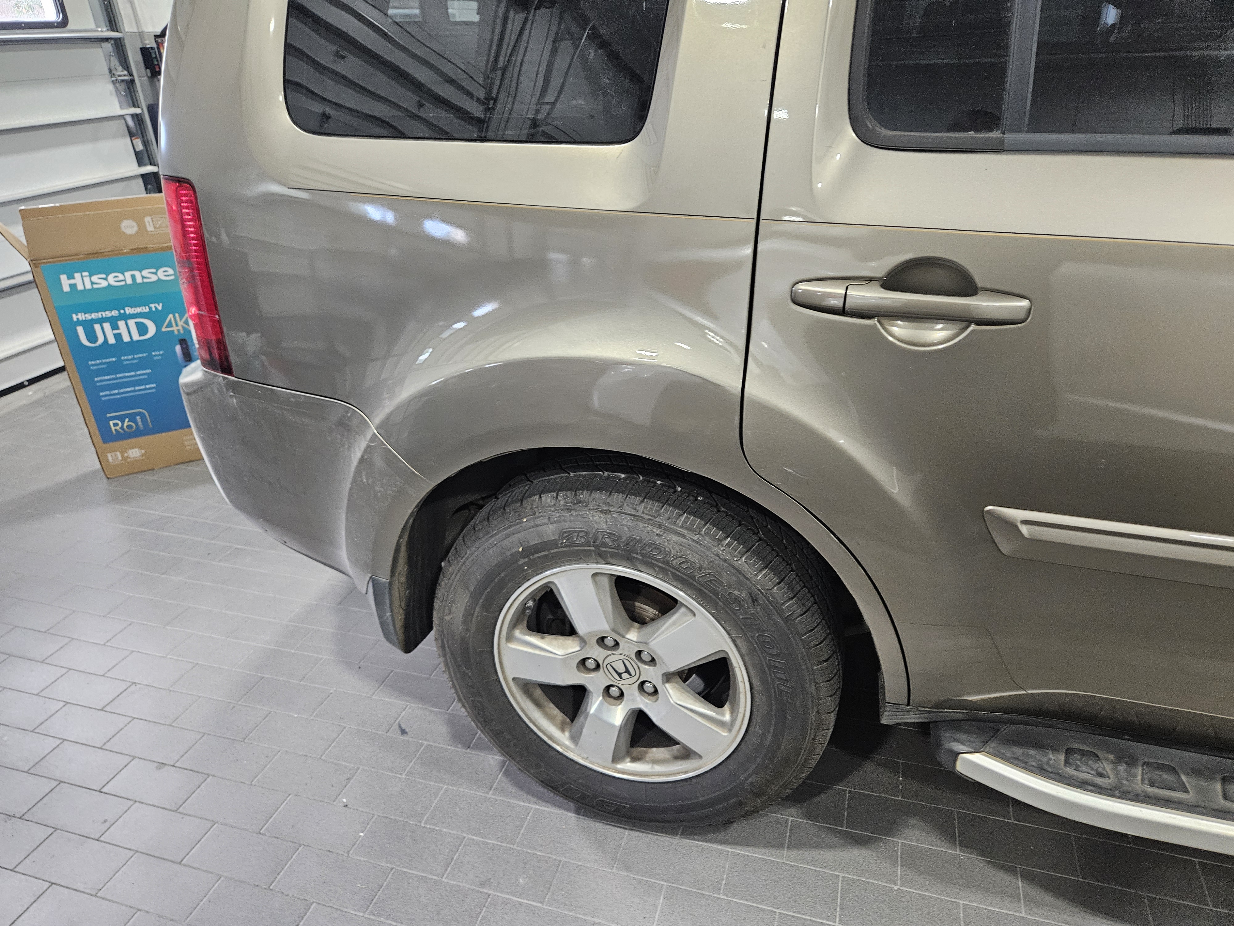 After photo of tan Honda Pilot rear quarter panel restored, refinished, and color-matched