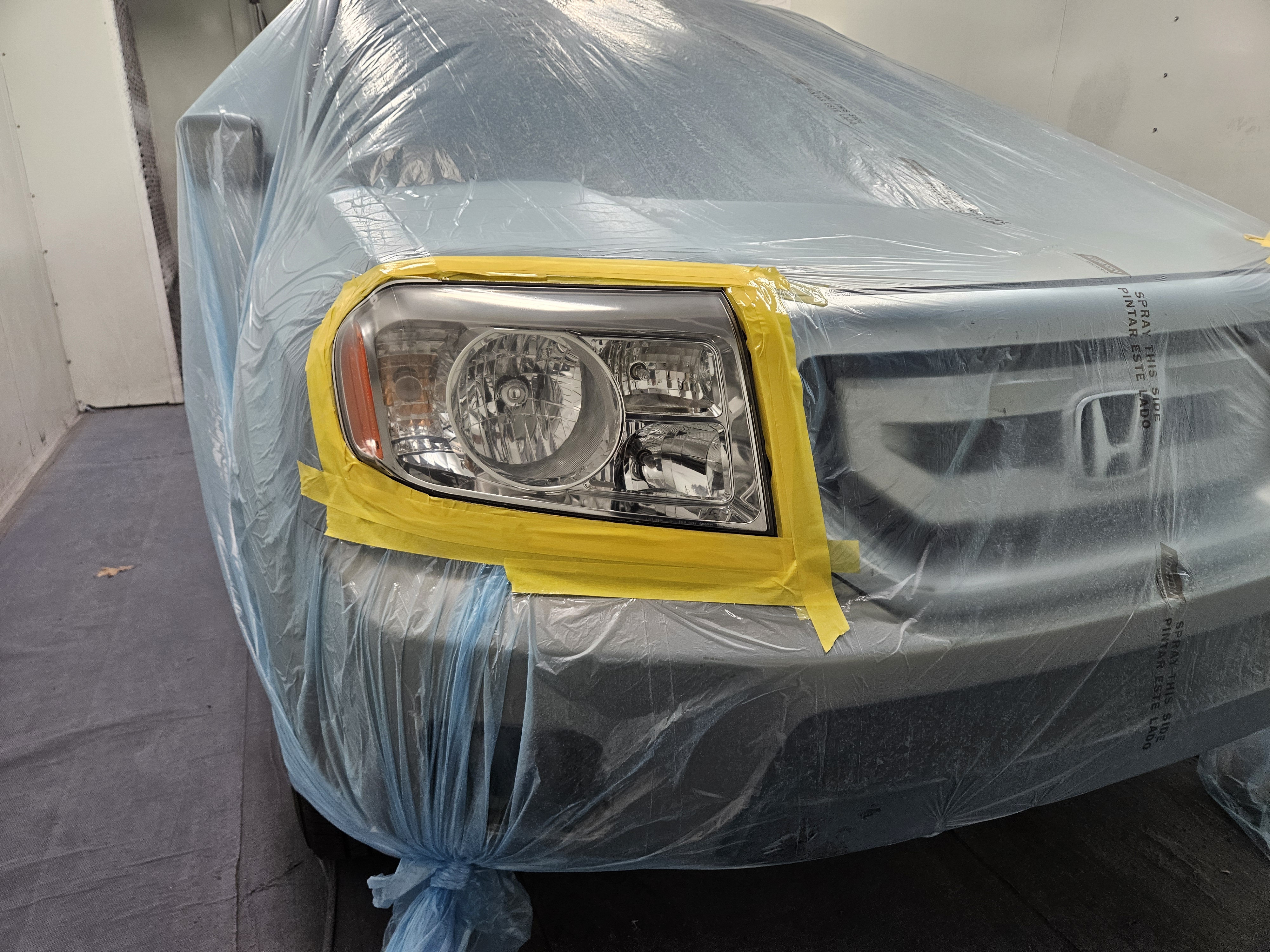After photo of restored Honda Pilot headlight lens, optically clear with UV sealant applied