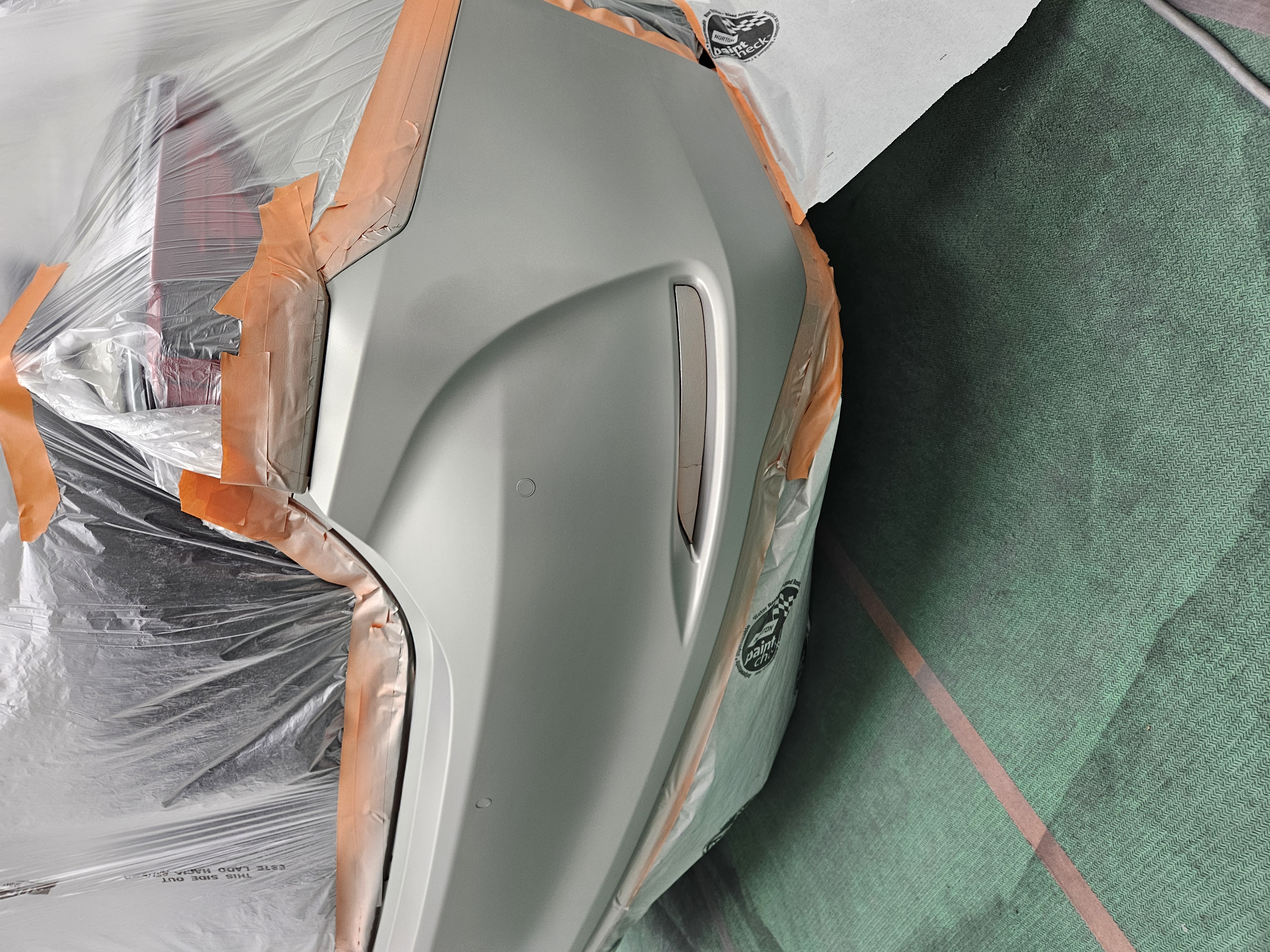 After photo of silver sedan rear bumper repainted and blended into the surrounding panels