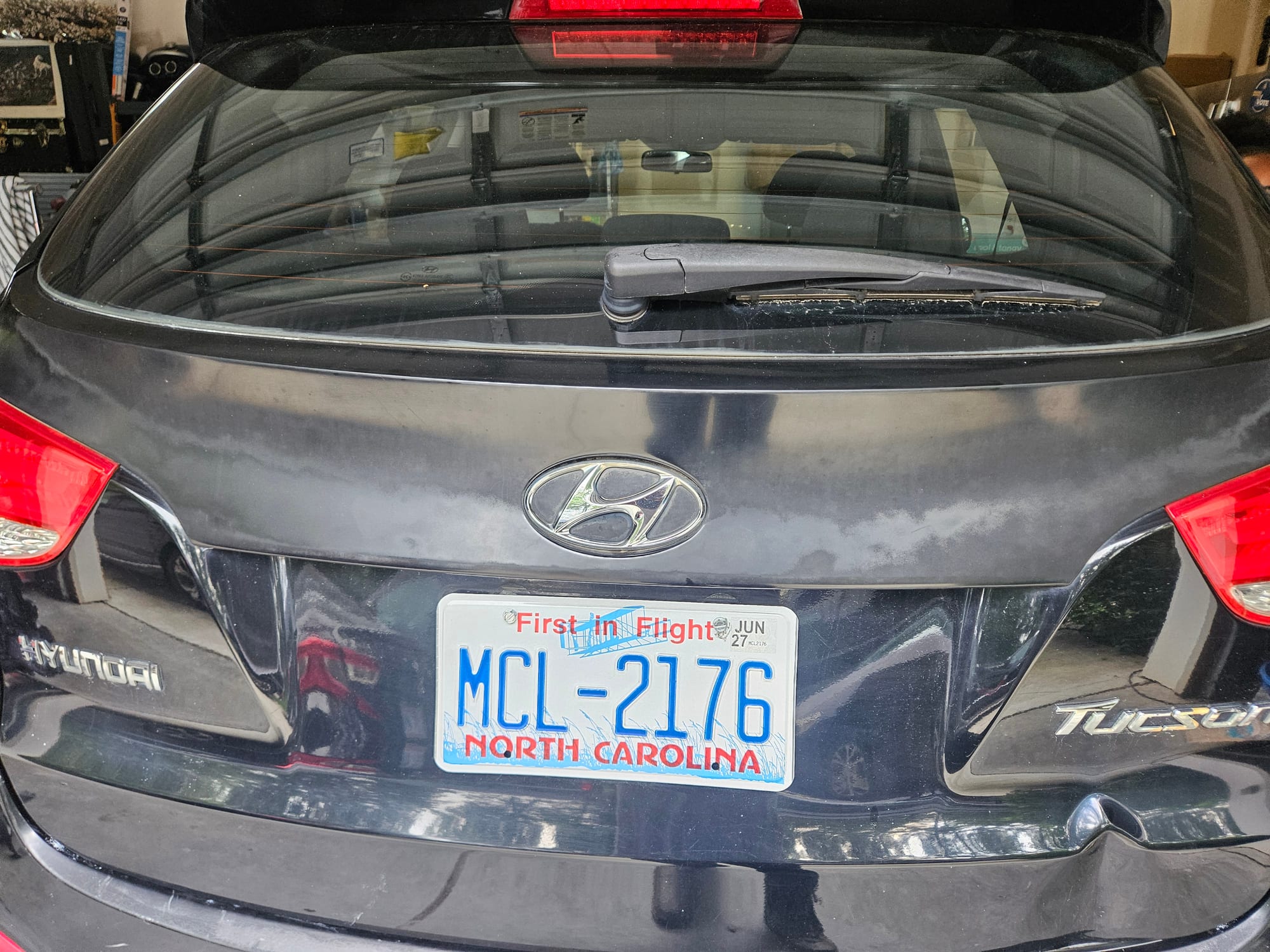 After photo of black Hyundai Tucson tailgate with the dent removed and factory finish restored